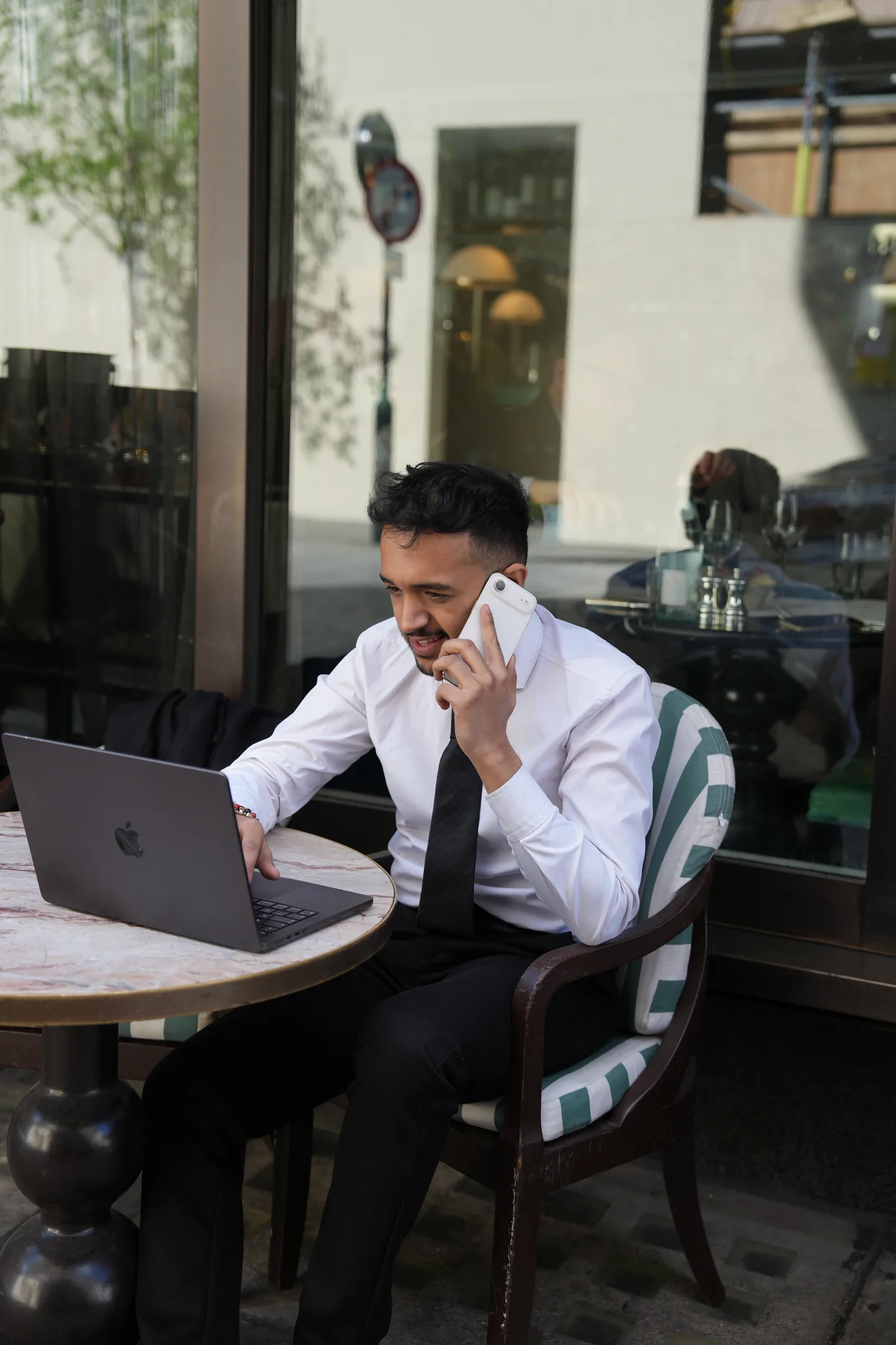 Varun Sharma working at a table with a laptop